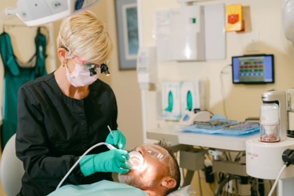 Staff working on a patient in the chair